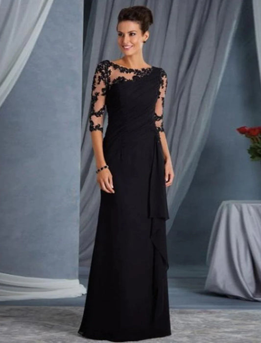 Woman wearing a black sheath evening gown with half sleeves and a jewel neck.