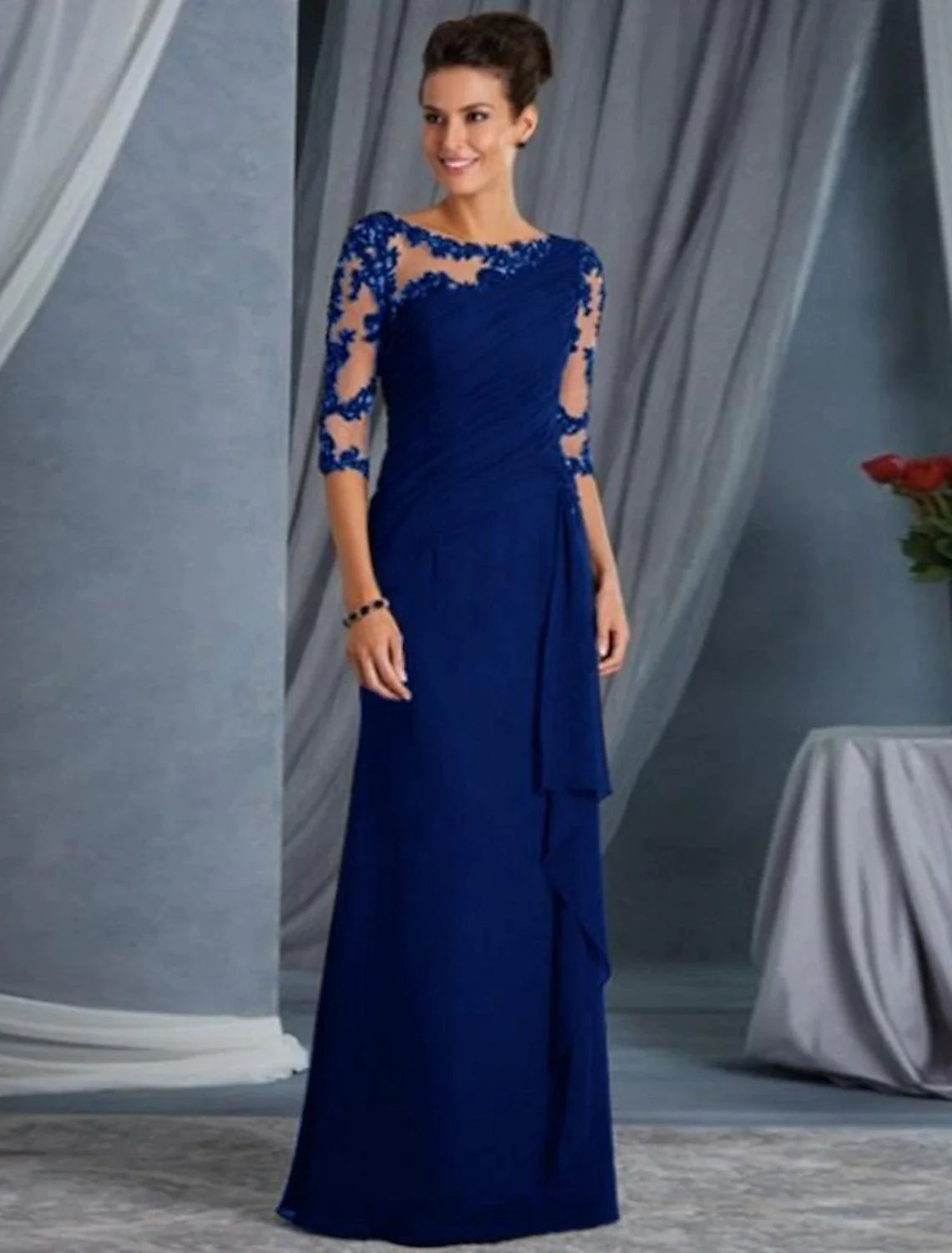 Close-up of the black evening gown's lace bodice and jewel neckline.