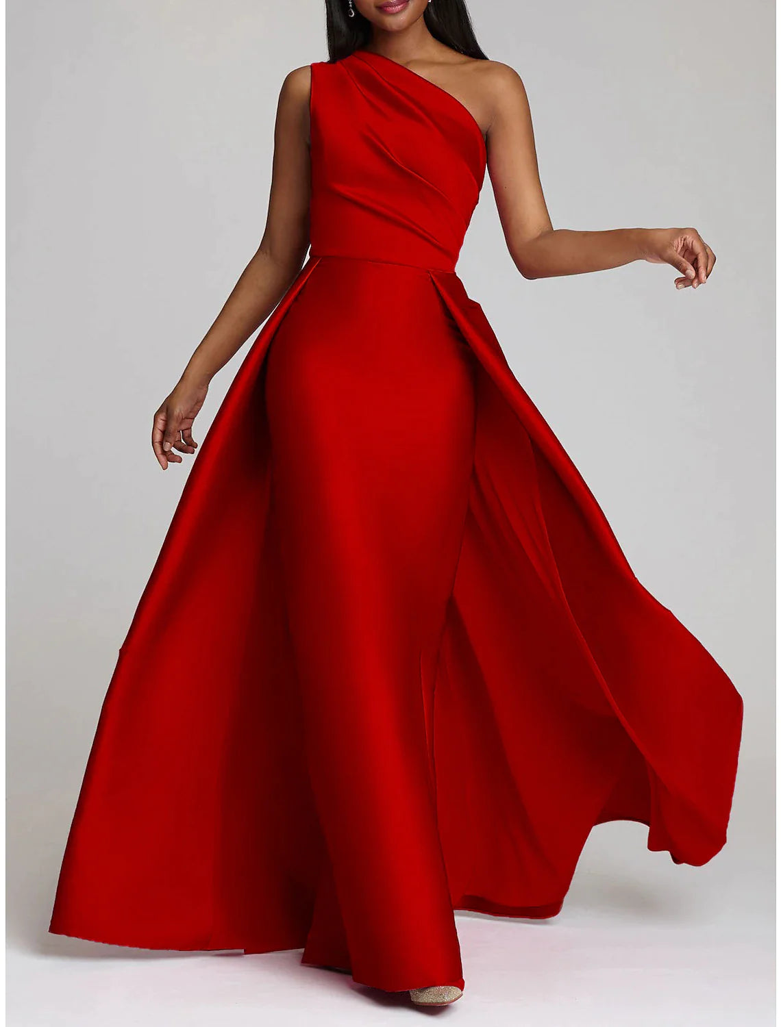 Model wearing a hot pink one-shoulder satin sheath gown with an overskirt.