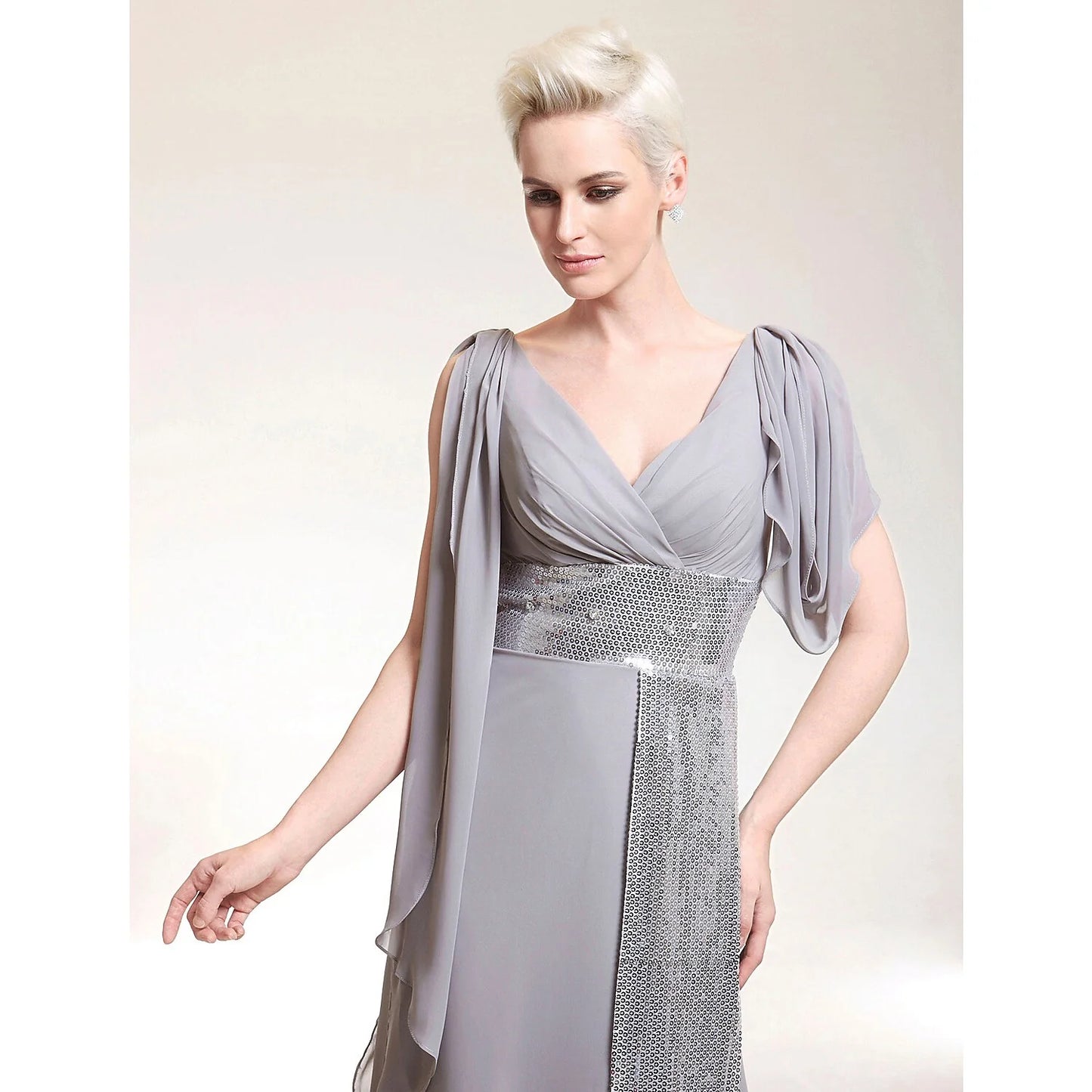 Back view of the floor-length sheath evening dress showcasing criss-cross beading details.