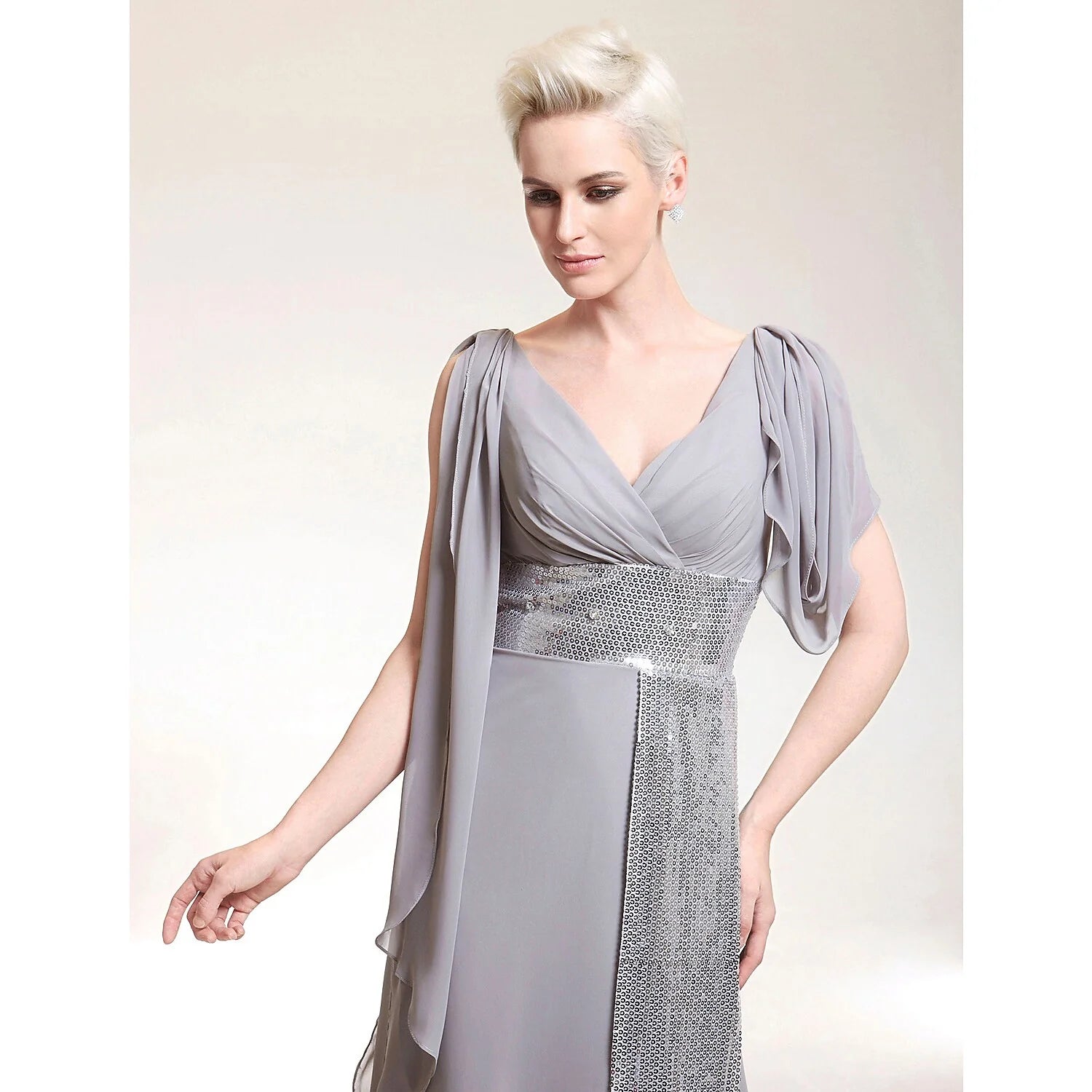 Back view of the floor-length sheath evening dress showcasing criss-cross beading details.