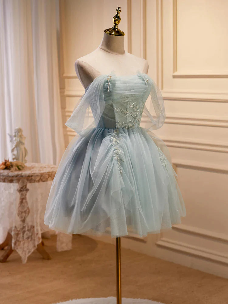 Side view of a model showcasing the flowing tulle skirt of the light green formal dress.