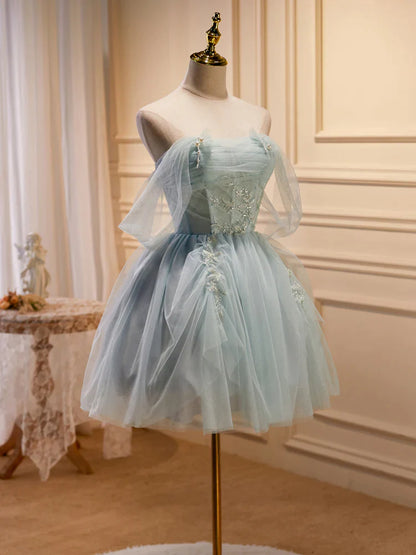 Side view of a model showcasing the flowing tulle skirt of the light green formal dress.