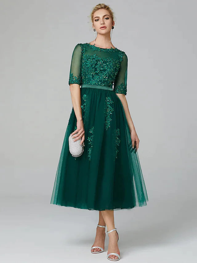 Model wearing a sparkle A-line tea-length formal dress with illusion neck and sequin lace.