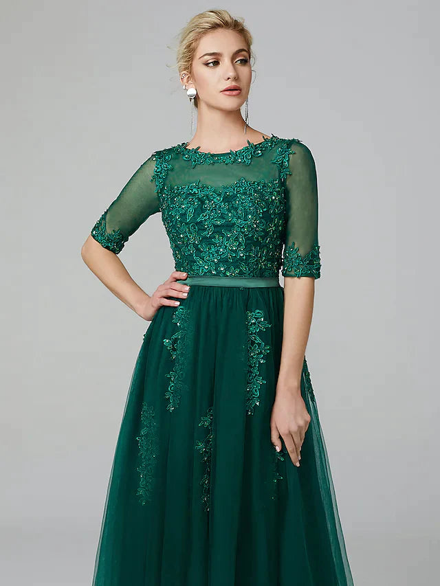 Side profile of the elegant tea-length wedding guest dress.