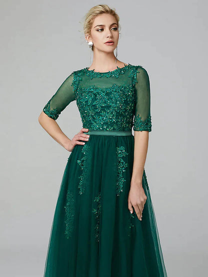 Side profile of the elegant tea-length wedding guest dress.
