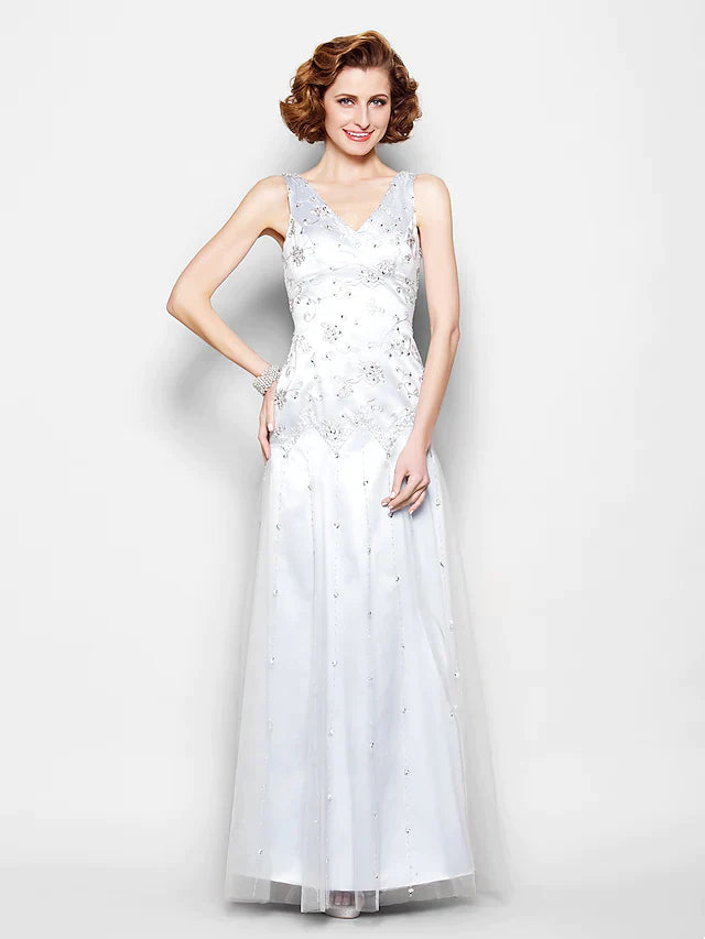 Woman in elegant V-neck sparkle lace tulle Mother of the Bride gown, front view.