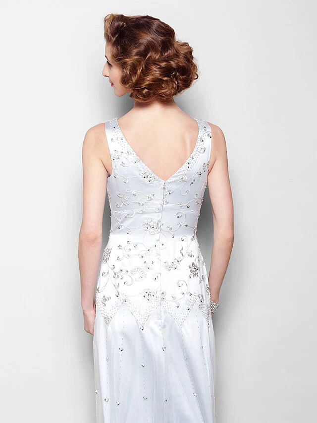 Woman posing gracefully in the elegant floor-length Mother of the Bride dress.