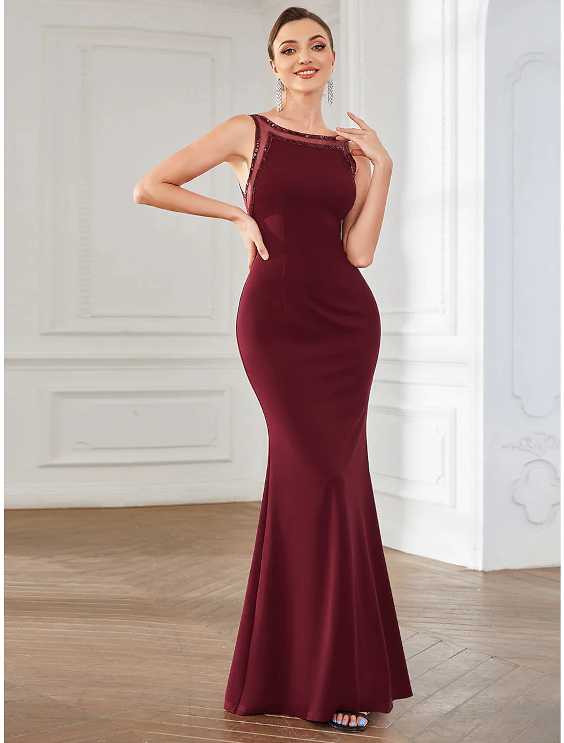 Side profile of a woman showcasing the mermaid trumpet silhouette of the dress.