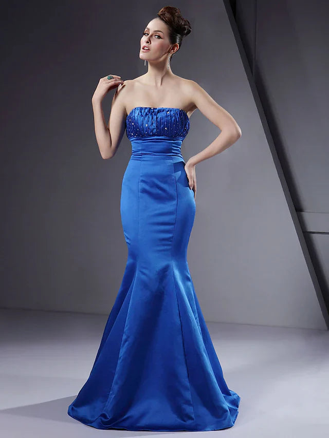 Woman wearing an elegant strapless floor-length satin bridesmaid dress with intricate beading and delicate draping.