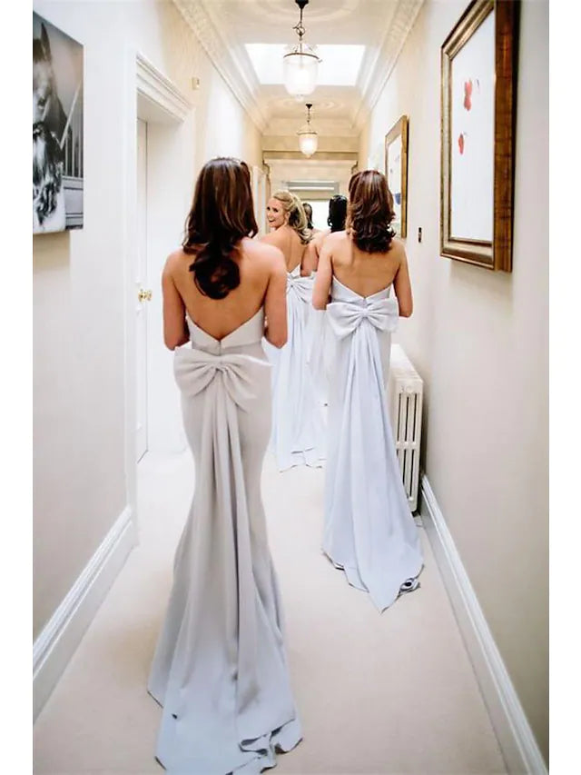 Close-up of the elegant light blue strapless jersey bridesmaid dress, highlighting ruffles and bow details.
