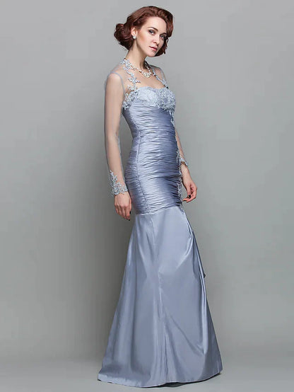 Full view of the dark blue gown, emphasizing the lace and taffeta fabric.
