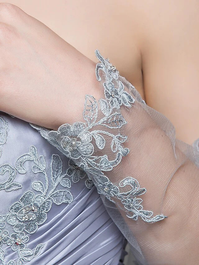 Detailed view of the lace pattern, taffeta texture, and intricate beading on the dress.