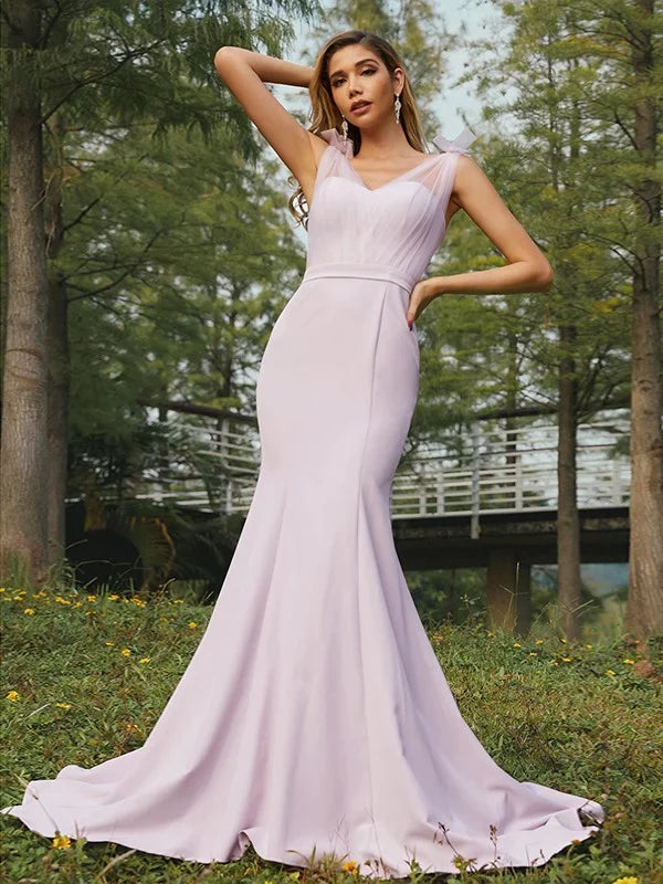 Woman wearing an elegant stretch crepe ruched V-neck sleeveless bridesmaid dress.