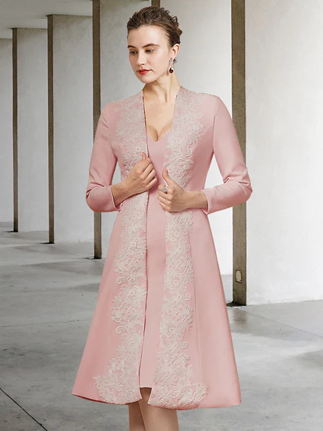 Woman wearing an elegant V-neck, half-sleeve, knee-length Mother of the Bride dress with appliques.