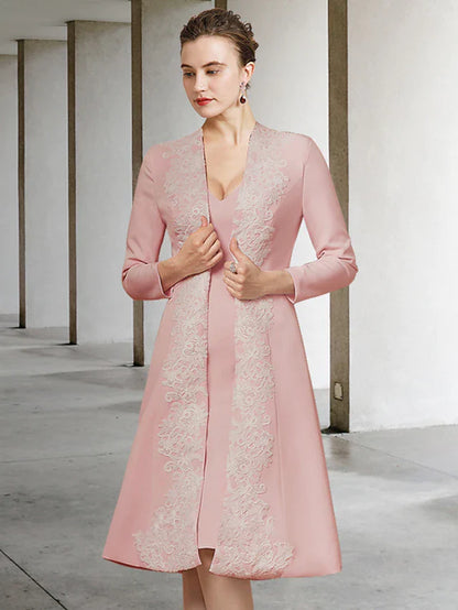 Woman wearing an elegant V-neck, half-sleeve, knee-length Mother of the Bride dress with appliques.