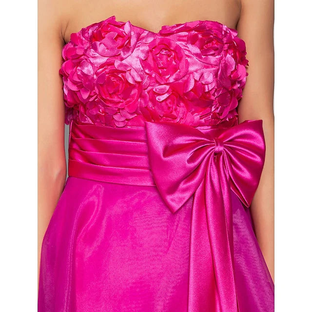 Back view of the ball gown dress, highlighting the open back and ribbon bow.