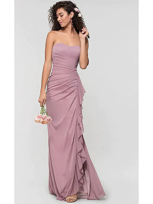 Woman wearing an elegant light blue sweetheart chiffon bridesmaid dress with ruffles, a split front, and an open back.