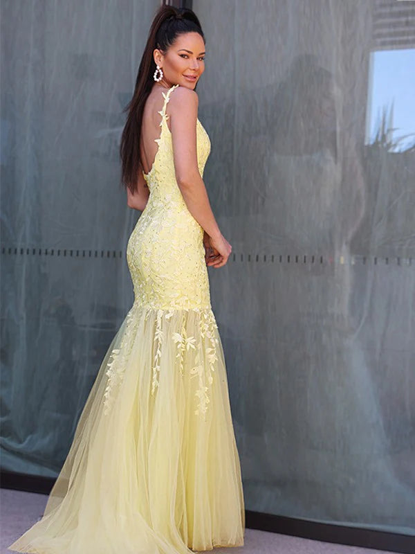 Side view of a long yellow prom dress, showcasing its flowing A-line skirt.