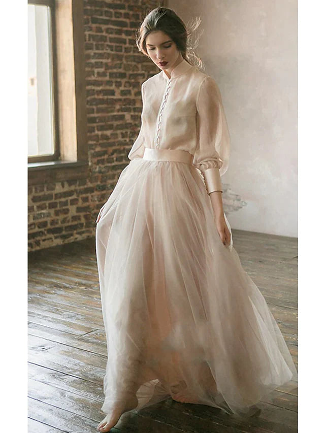 Back view of the floor-length tiered skirt on the minimalist gown.