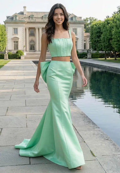 Side view of the two-piece mint green satin prom dress, showing the fitted mermaid skirt and crop top with pearl straps.
