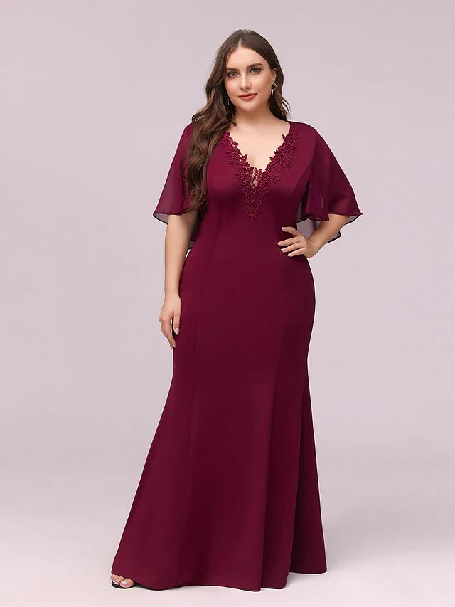 Close-up of the V-neckline and delicate appliques on the chiffon dress.