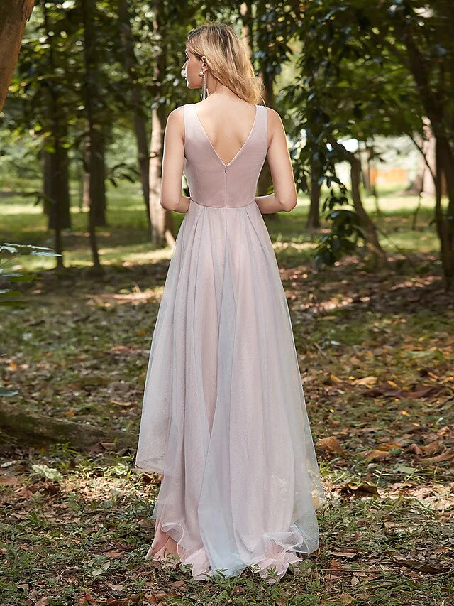 Side profile of the asymmetrical tulle bridesmaid dress, showcasing the delicate appliques and flowing design.
