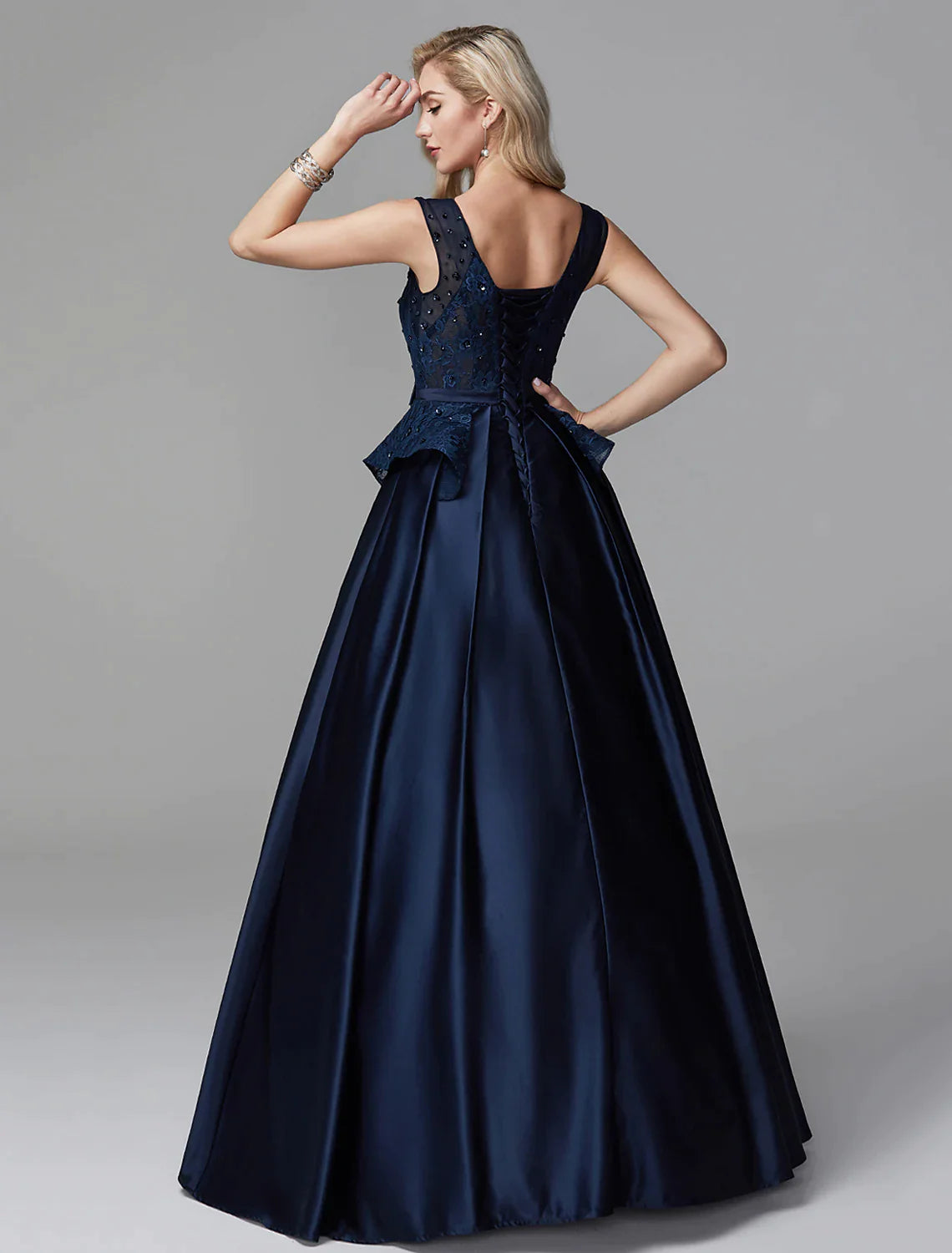 Close-up of the V-neckline and intricate lace on the ball gown.