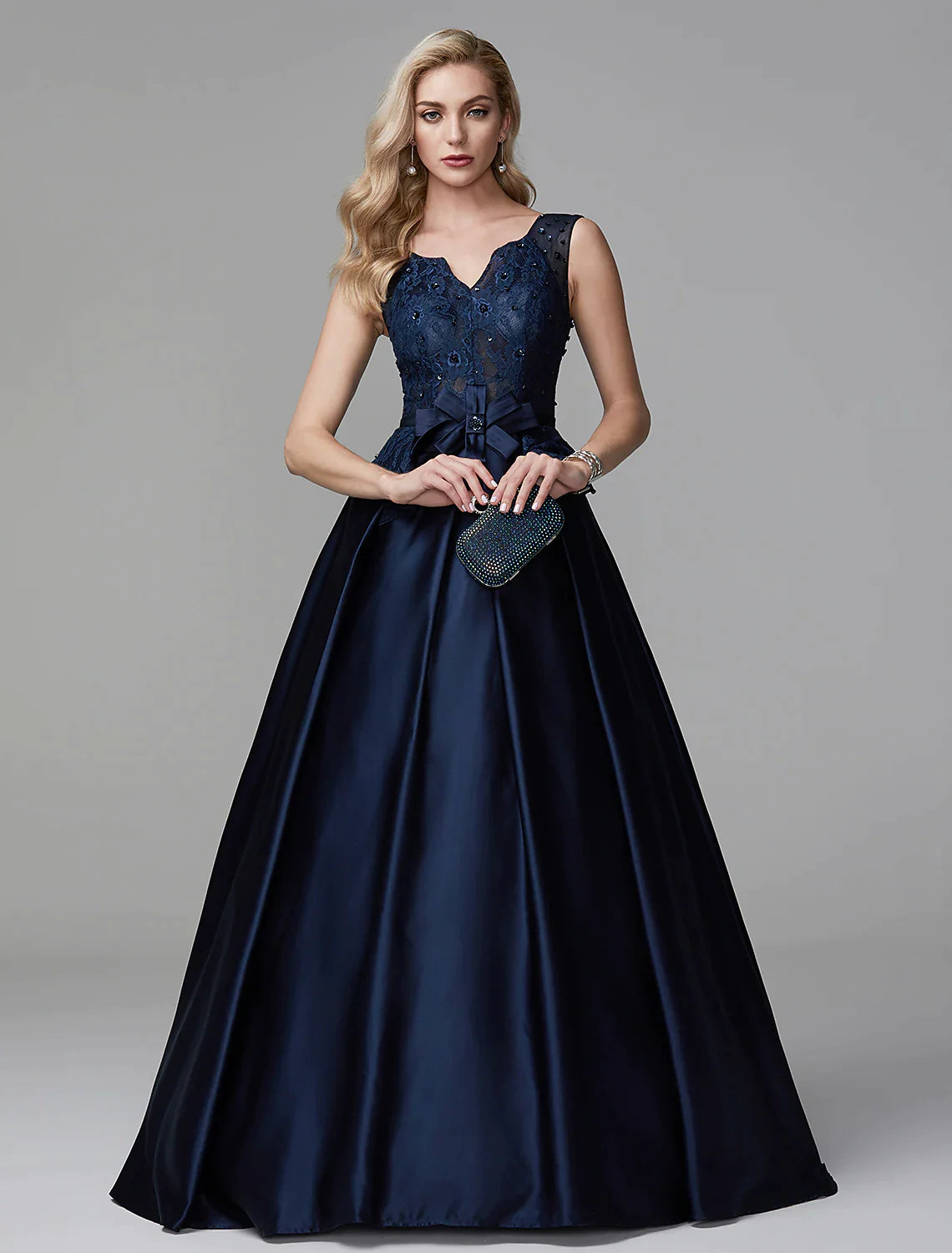 Side view of the model in the ball gown, highlighting the peplum and silhouette.