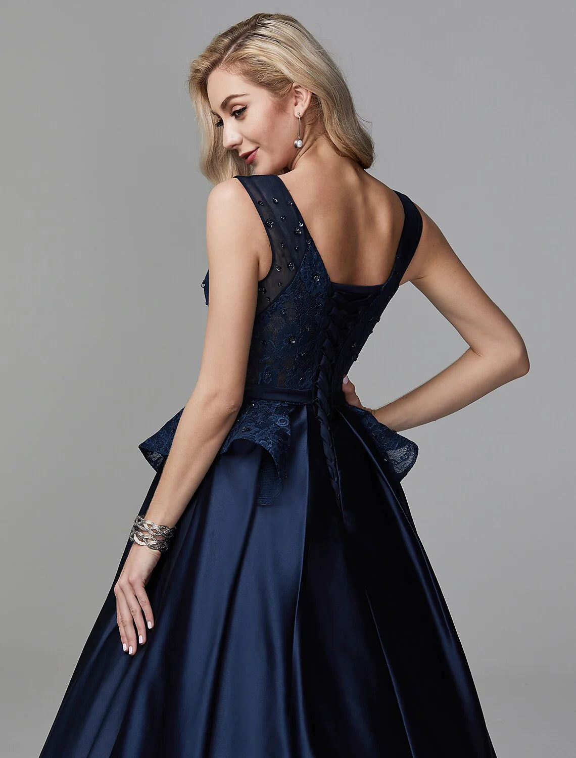 Full length view of the ball gown, featuring lace appliques and beading.
