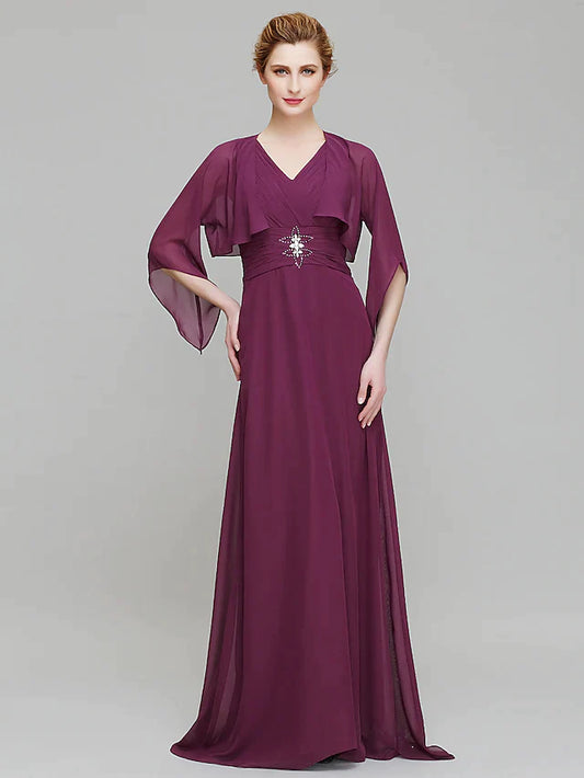 Woman in elegant V-neck chiffon Mother of the Bride dress with 3/4 sleeves and criss-cross crystals.