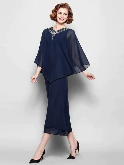 A woman wearing an elegant V-neck chiffon tea length dress with 3/4 sleeves and crystal beading.