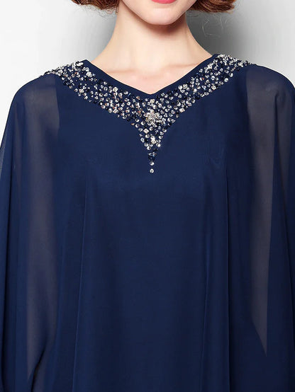Close-up of the V-neckline and intricate crystal beading on the bodice of the dress.