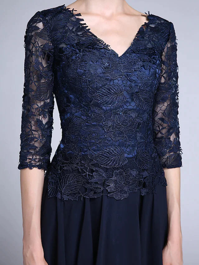 Close-up of the sheer lace half sleeve and V-neckline on the chiffon dress.