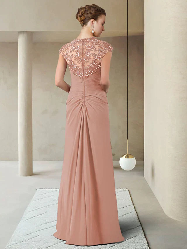 Back view of a woman wearing a floor-length chiffon lace Mother of the Bride gown.
