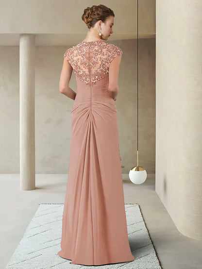 Back view of a woman wearing a floor-length chiffon lace Mother of the Bride gown.