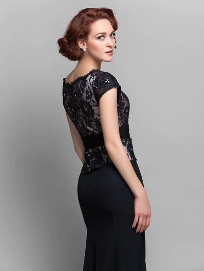 Detailed view of the lace appliques and short sleeves of the formal Mother of the Bride gown.