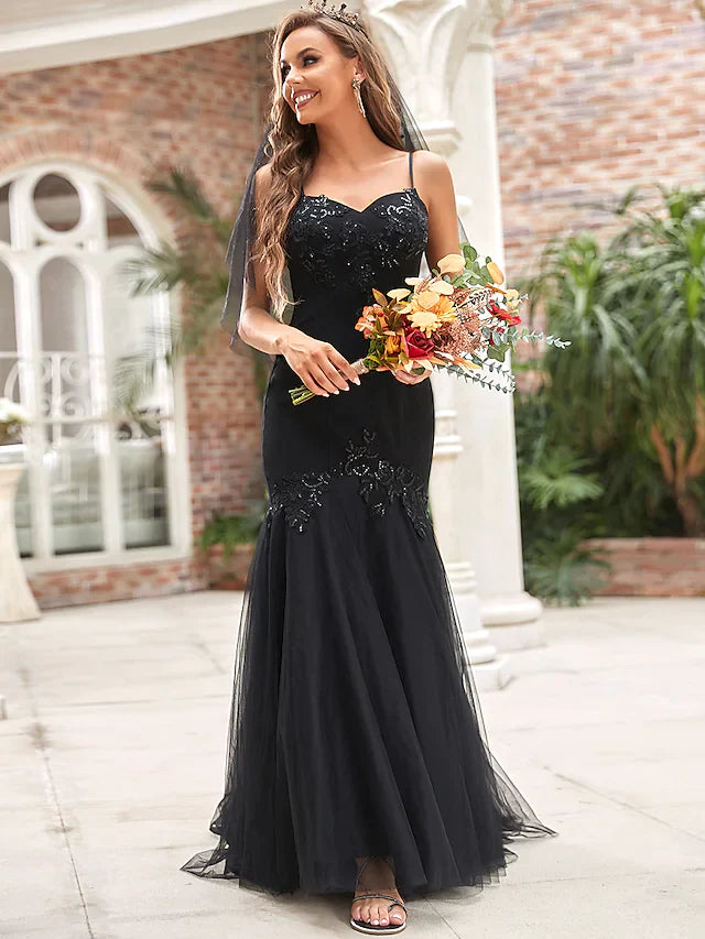 Model wearing an elegant V-neck tulle wedding dress with sequin appliques.