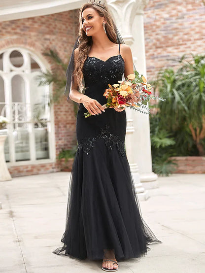 Model wearing an elegant V-neck tulle wedding dress with sequin appliques.