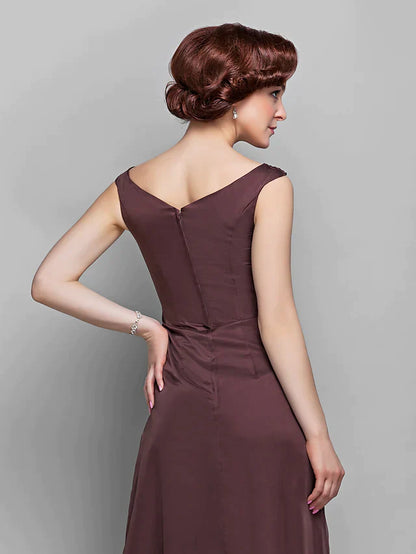 Close-up of the V-neckline and crystal embellishments on the chiffon Mother of the Bride dress.