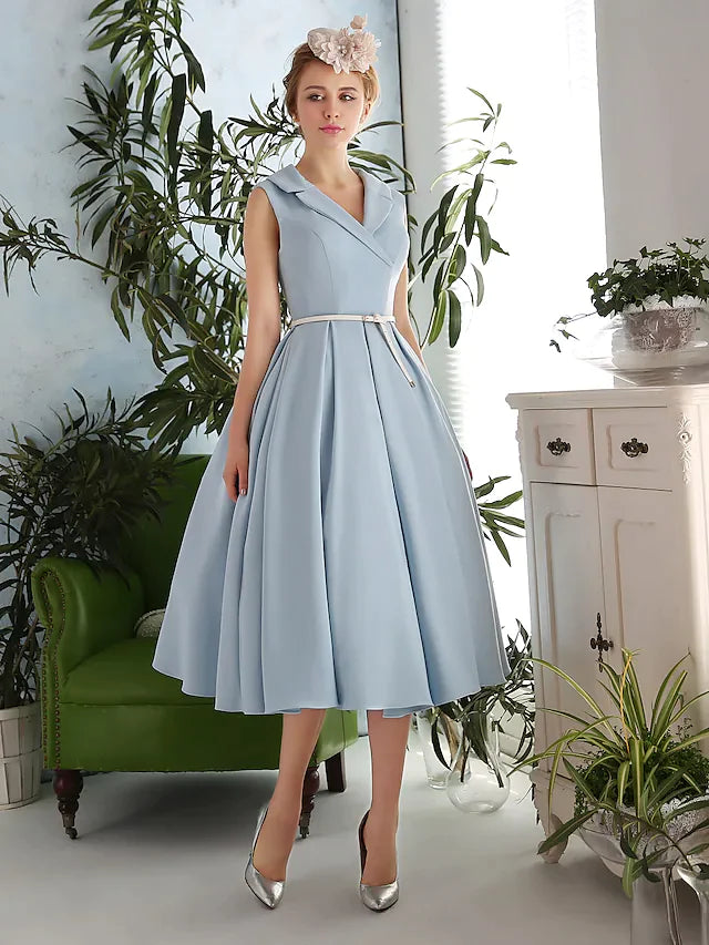 Woman wearing an elegant A-line V-neck tea-length dress with a sash ribbon.