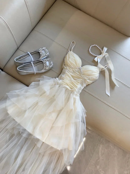 Elegant A-Line Sweetheart Pearl Ruffled Tulle Champagne High-Low Homecoming Dress