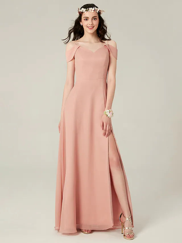 Woman wearing a flowy A-line chiffon bridesmaid dress with spaghetti straps and a split front.