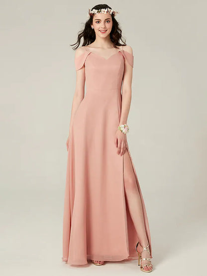 Woman wearing a flowy A-line chiffon bridesmaid dress with spaghetti straps and a split front.