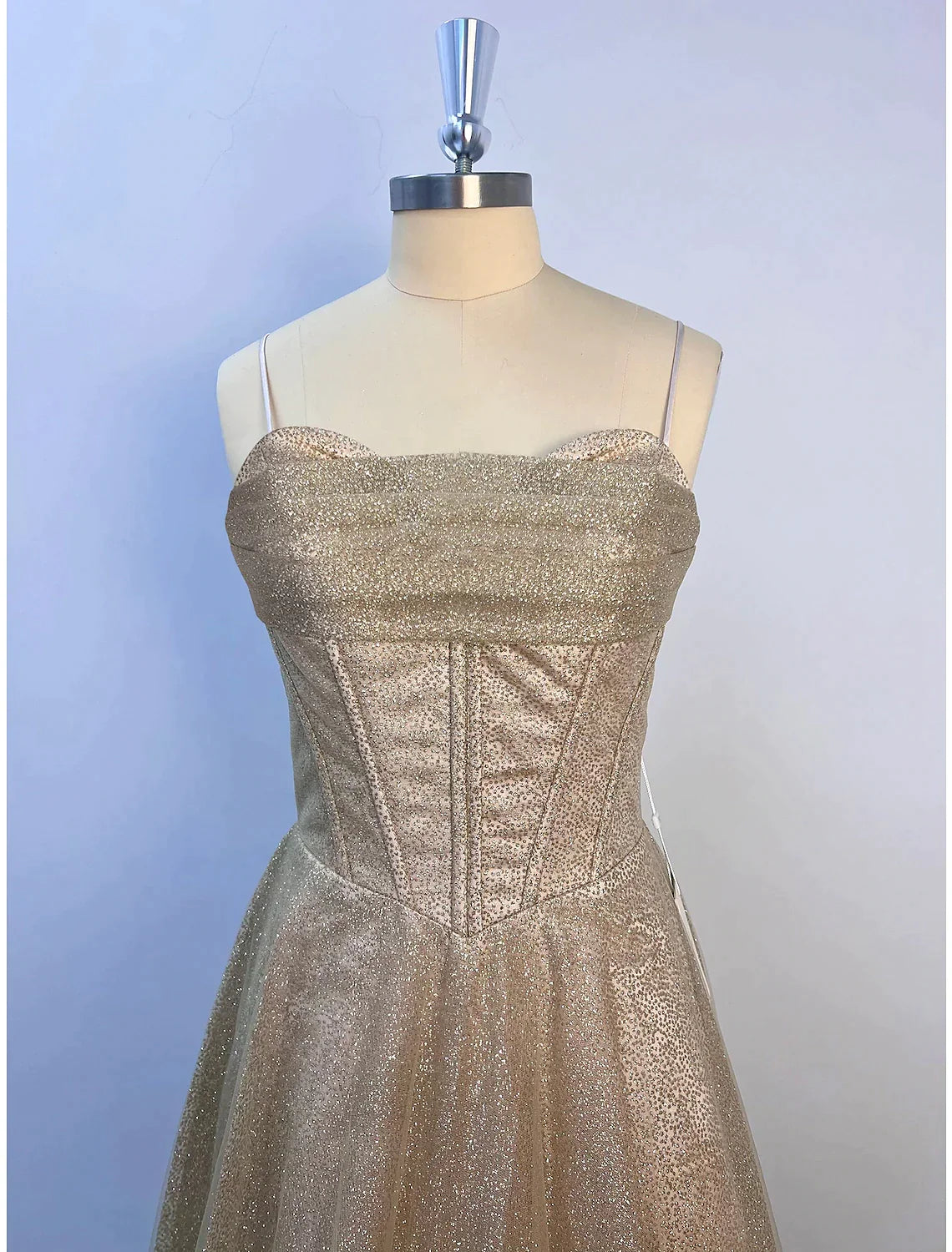 Full view of a floor-length A-line evening gown with shimmering glitter details.