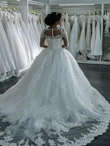 Side view of backless A-line wedding dress with lace long sleeves and court train.