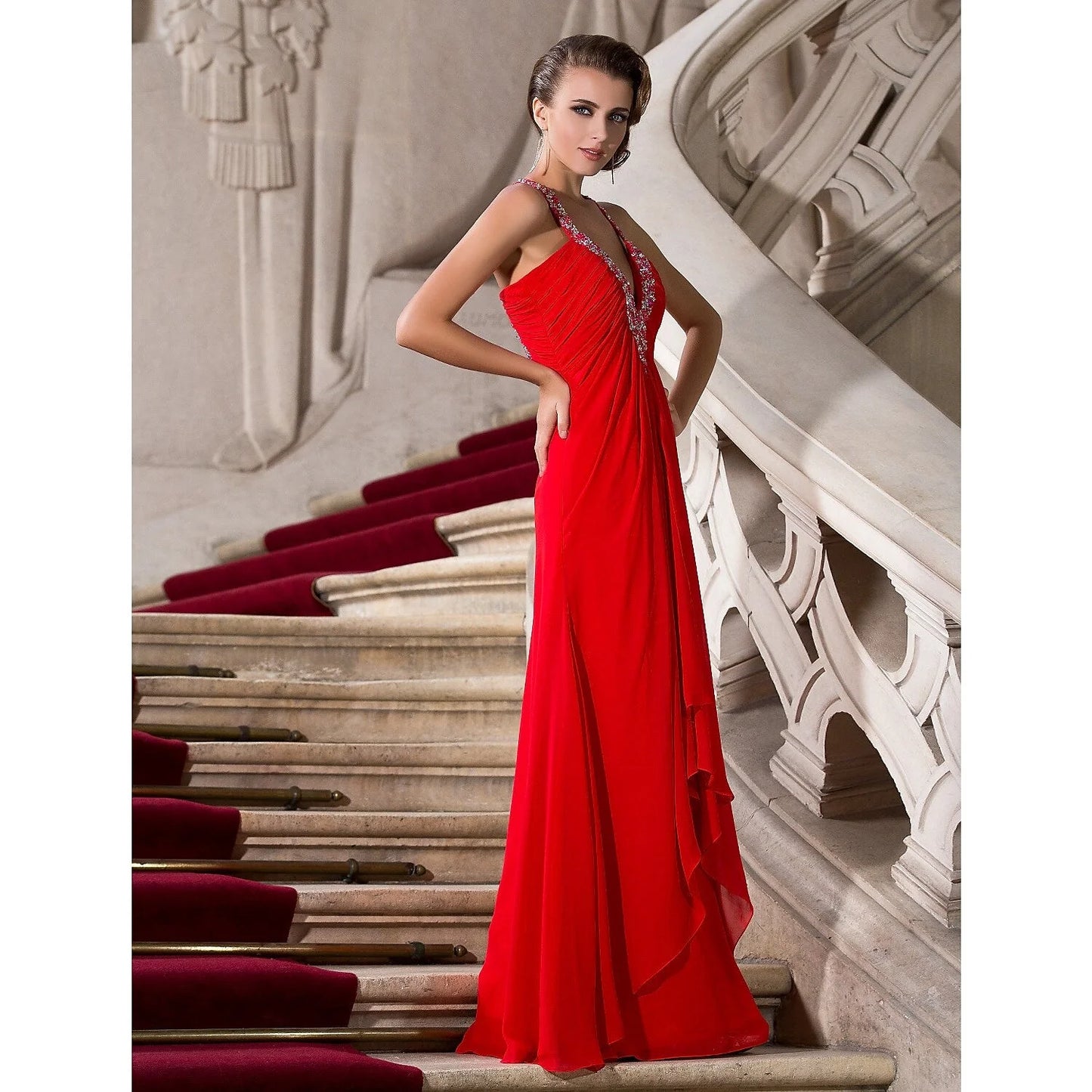 Model wearing a glamorous A-line plunging neck beaded chiffon evening gown.