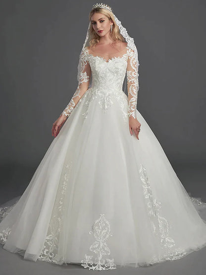 Bride in a glamorous ball gown wedding dress with illusion neck and long lace sleeves, chapel train.