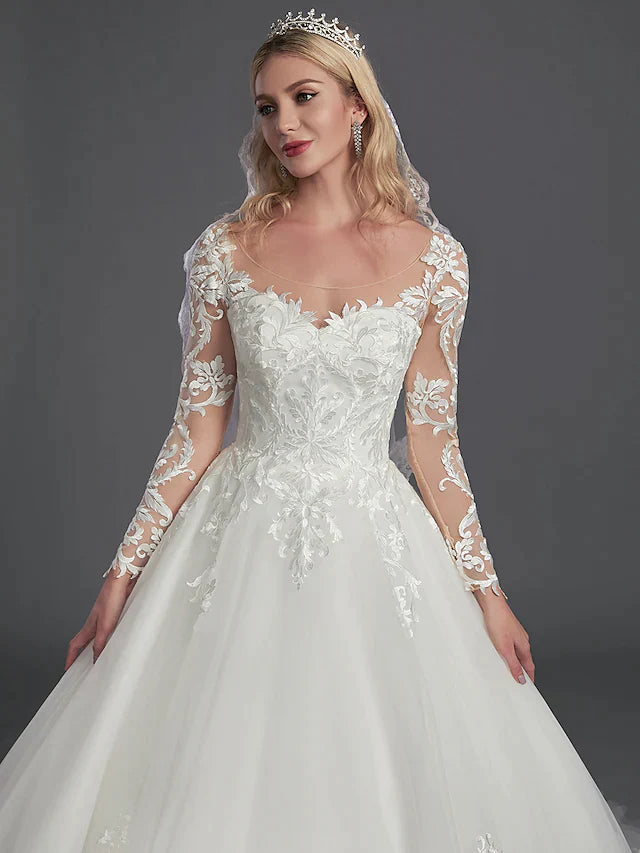 Back view of the wedding dress, highlighting the illusion back with button details and lace appliques.