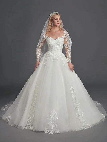 Bride from behind, showing the elegant chapel train and detailed illusion back of the ball gown.
